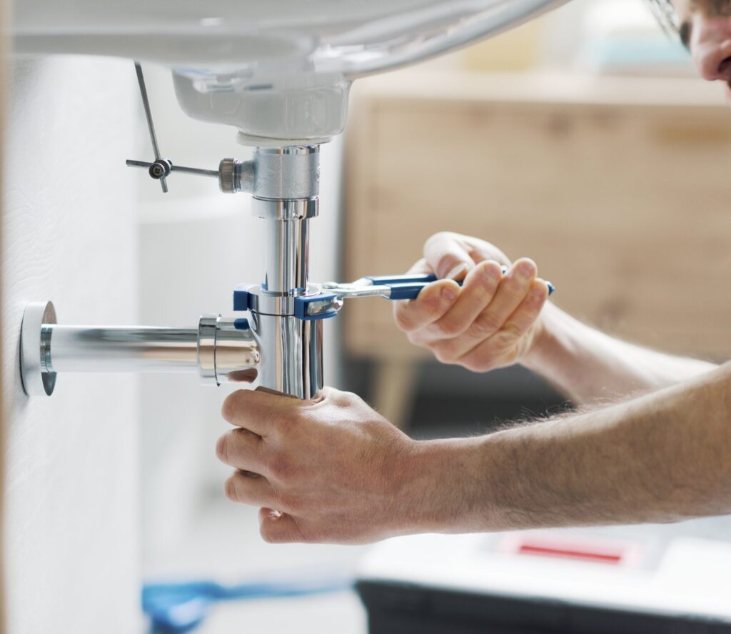pipe under sink being tightened
