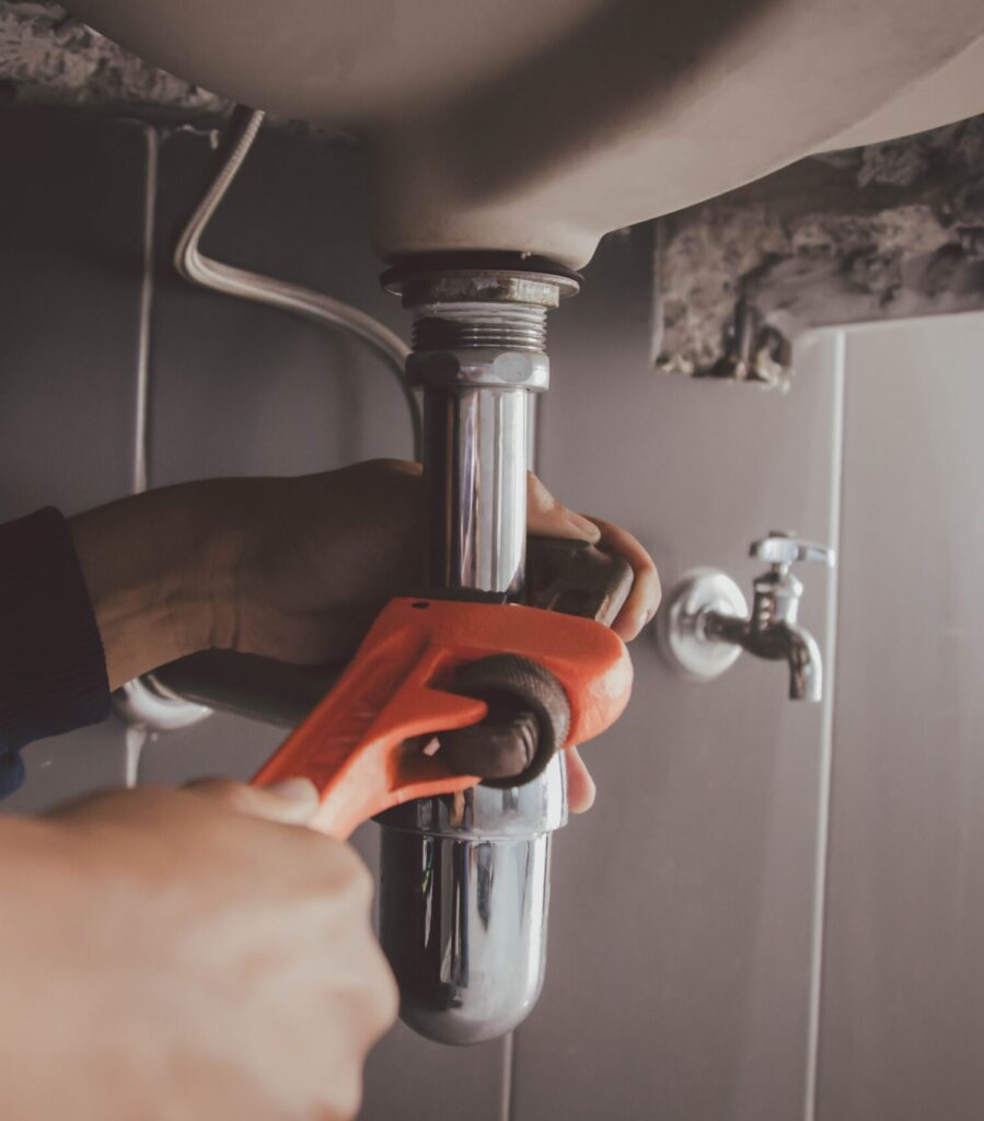 Pipe under sink being fixed