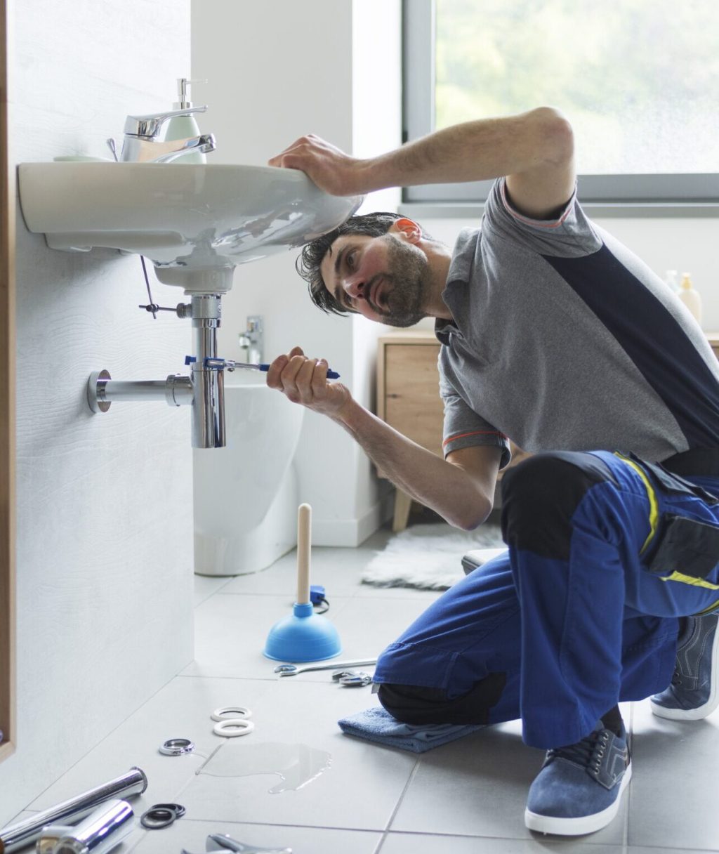 Professional,Plumber,Checking,Drain,Pipes,At,Home,And,Using,Pliers professional plumber fixing pipes