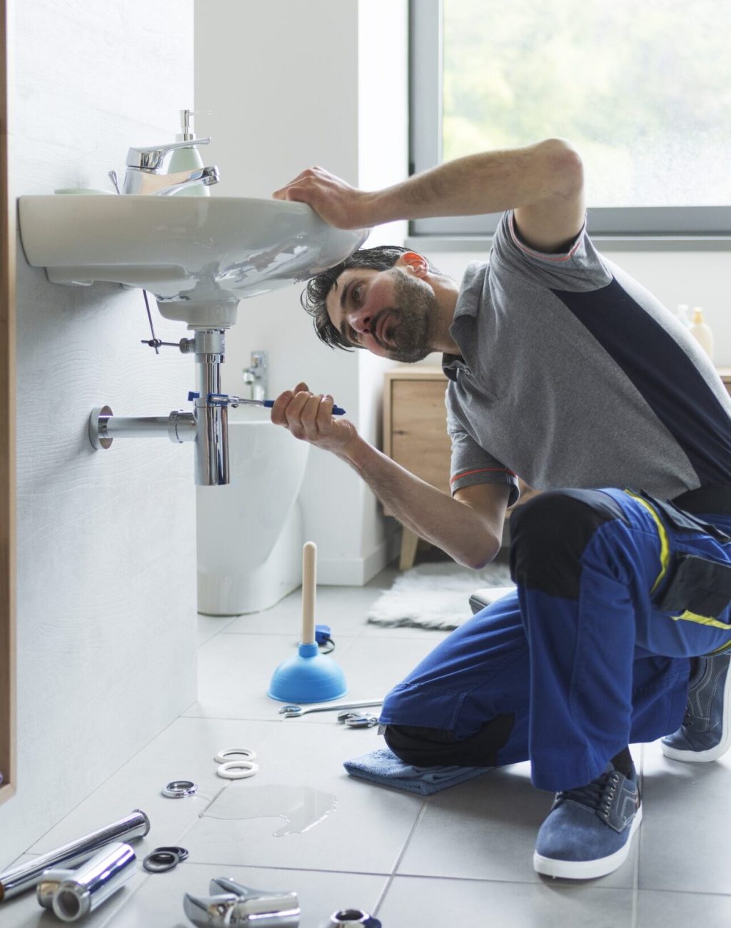 Professional,Plumber,Checking,Drain,Pipes,At,Home,And,Using,Pliers professional plumber fixing pipes